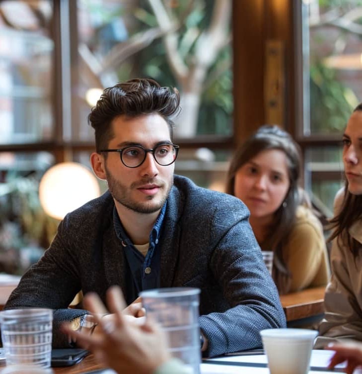 Man talks with friends in a cafe about his depression treatment in Northwest Arkansas
