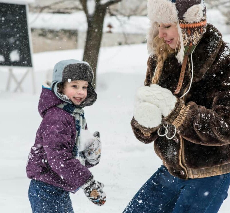 Woman and child play together in the snow to show health attachment as taught by Dr. Mate